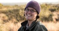person in stocking cap with grasslands behind 